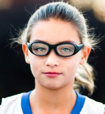 Child athlete wearing safety goggles while playing basketball to prevent eye injuries