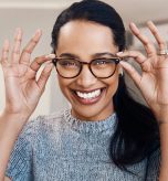 Patient trying on new eyeglasses at The Eye Care Center before year-end FSA and vision benefits expire