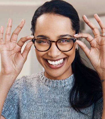 Patient trying on new eyeglasses at The Eye Care Center before year-end FSA and vision benefits expire