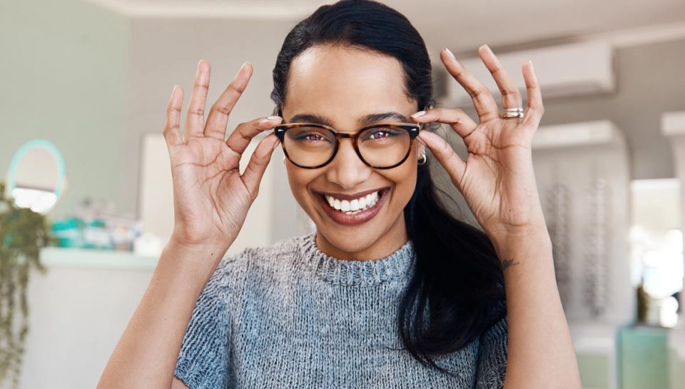 Patient trying on new eyeglasses at The Eye Care Center before year-end FSA and vision benefits expire